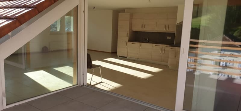 glass sliding door, tile floor, wooden kitchen cabinets, countertop, backlit cabinets, sink with faucet