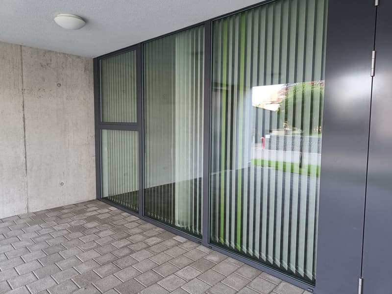tiled floor, large glass doors, concrete wall, outdoor view