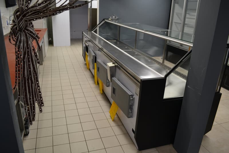 tiles floor, glass and stainless steel display case, white and gray cabinets, white ceiling