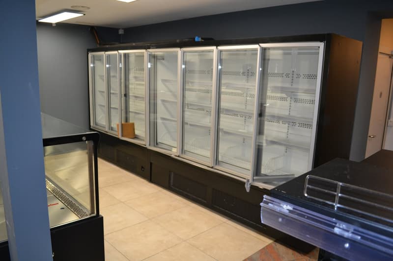 commercial freezers, tiled floor, interior walls, wooden door, display cases