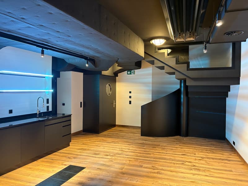 modern kitchen, wooden flooring, sink with faucet, cabinets, white walls, ceiling lights, staircase, double doors, emergency exit sign