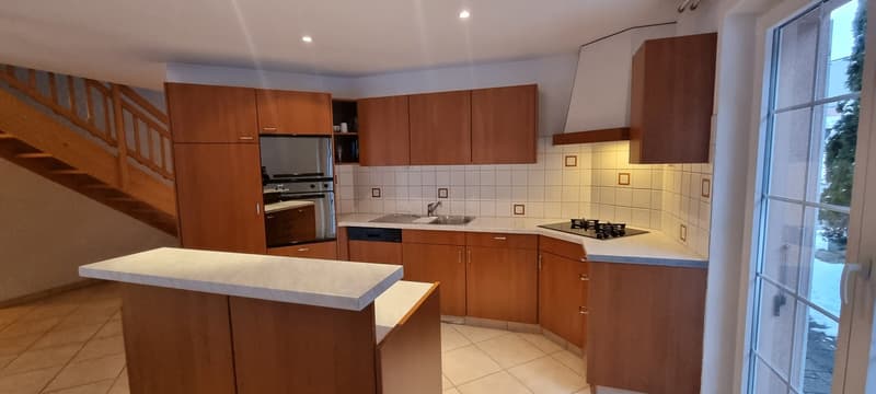 modern kitchen with wooden cabinets, white countertops, gas stove, oven, dishwasher, sink, and a window