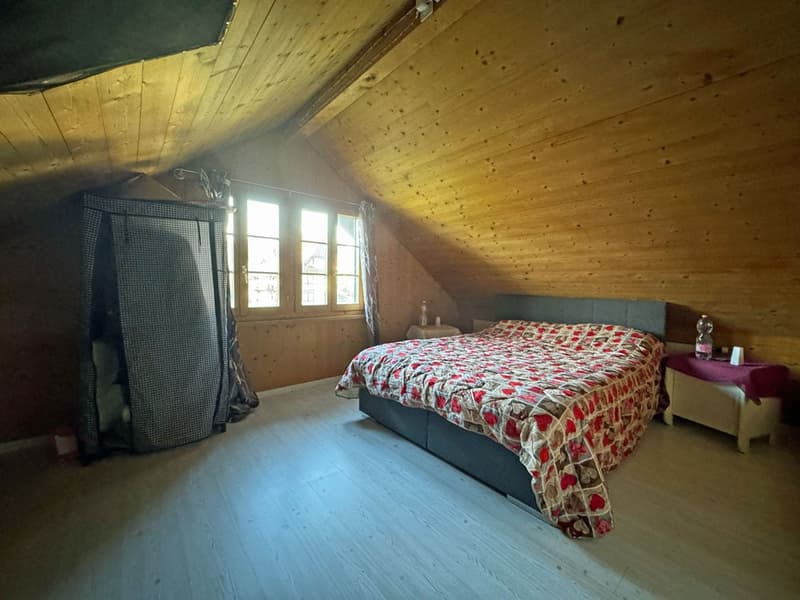 bedroom with wooden ceiling, bed, nightstand, window, and a curtain