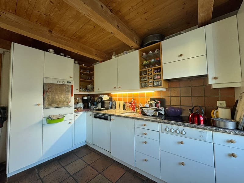 modern kitchen with white cabinets, granite countertops, dishwasher, washing machine, wooden ceiling