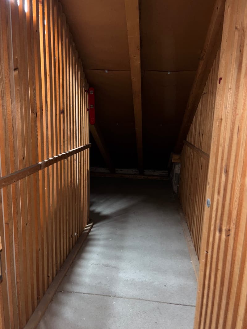 wooden walls, grey concrete floor, fire extinguisher