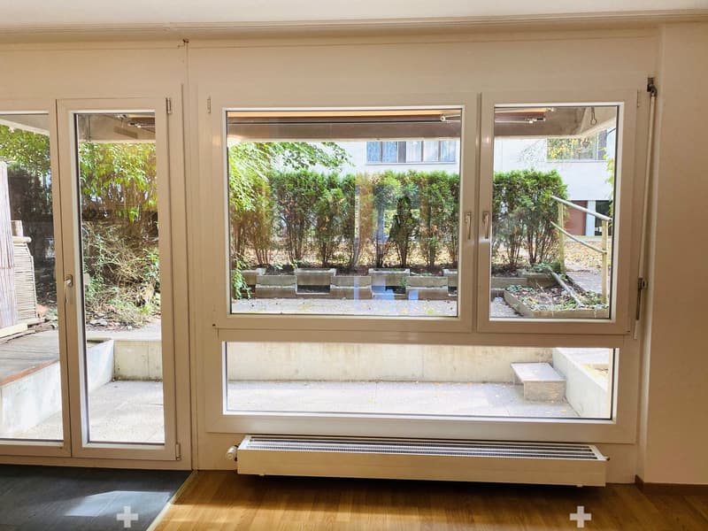 sliding glass doors, white walls, white floor, white ceiling, windows with outside view