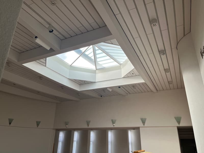 white ceiling, glass skylight, white walls, wall lamps, white windows