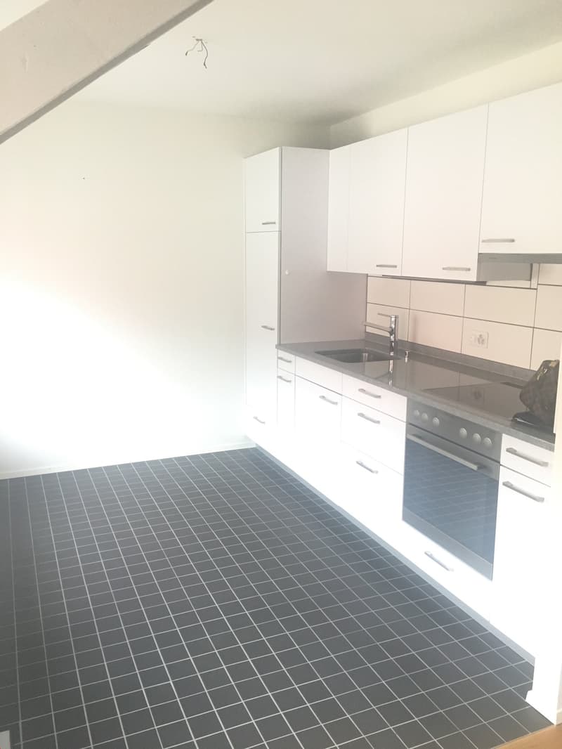 modern kitchen, tiled floor, white cabinetry, granite countertop, integrated dishwasher, washing machine, stainless steel stove, and a sink with faucet