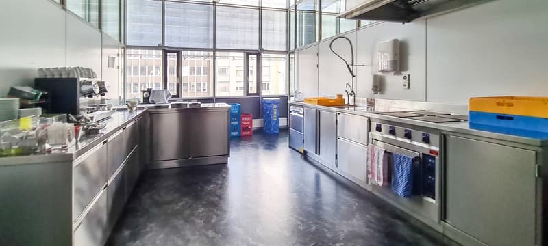 commercial kitchen with stainless steel cabinets, gas stove, oven, and sink