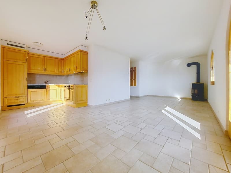 empty kitchen with wooden cabinets, tiled floor, hanging light, fireplace