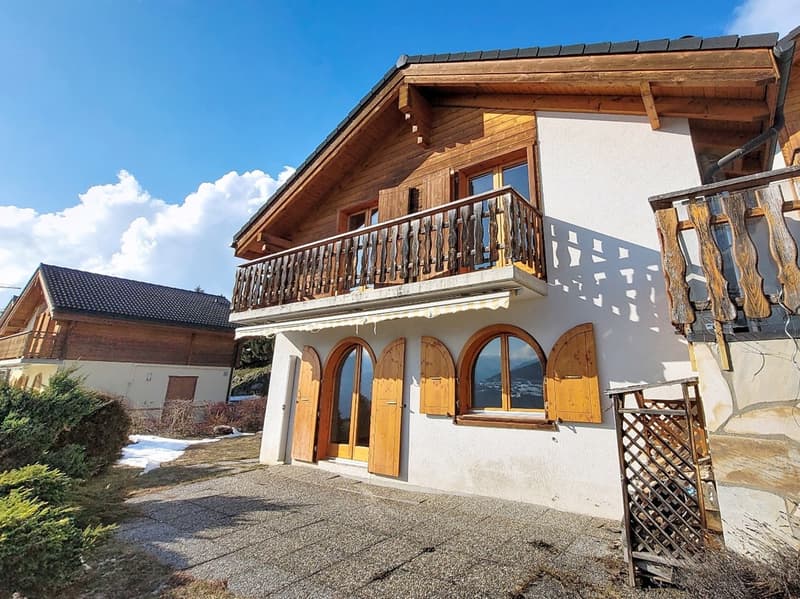 2 story house, wooden exterior, white walls, balcony, wooden doors, windows