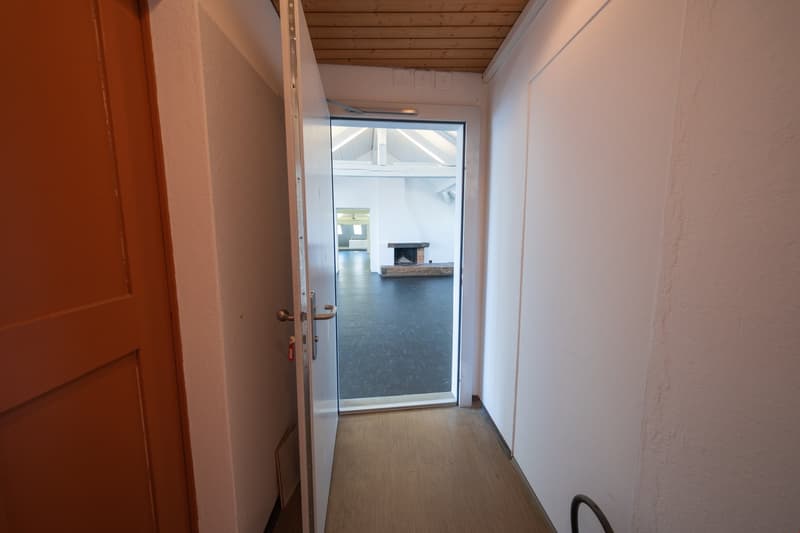 White walls, wooden floor, open door, white ceiling, empty room, fireplace