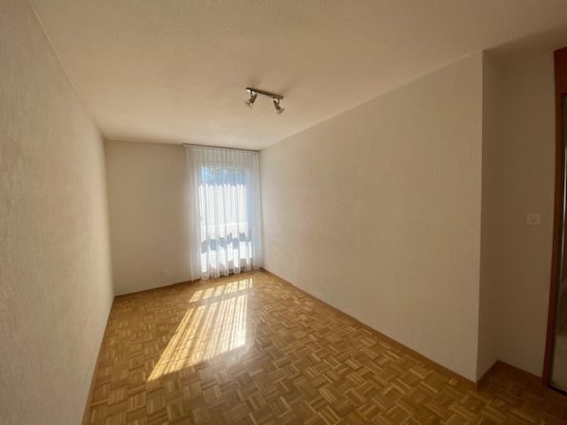 empty room, wooden floor, white walls, white window with white curtains, wall switch