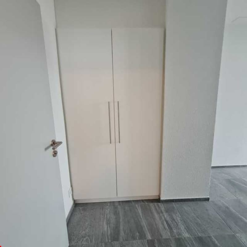 Empty room with double closet, tiled floor, white walls