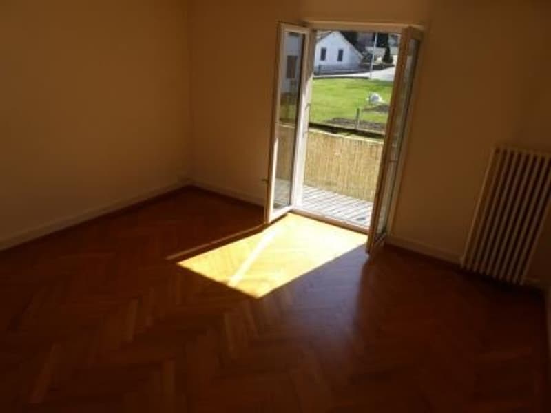 empty room, hardwood floors, sliding door leading to a balcony, large windows