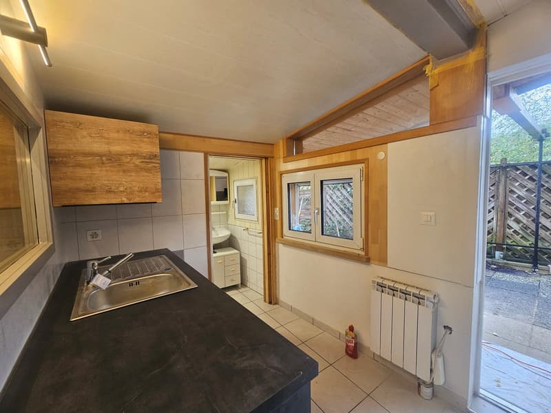 kitchen, wooden cabinets, granite countertop, stainless steel sink, open window, tile flooring