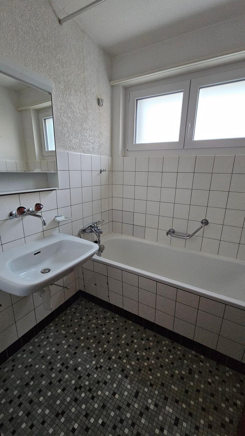 tiled walls, bathtub, sink, white tile floor, mirror