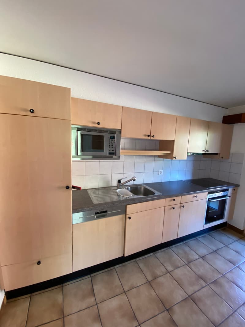 modern kitchen with wooden cabinets, granite countertops, stainless steel sink, built-in microwave, dishwasher, gas stove, tiled floor