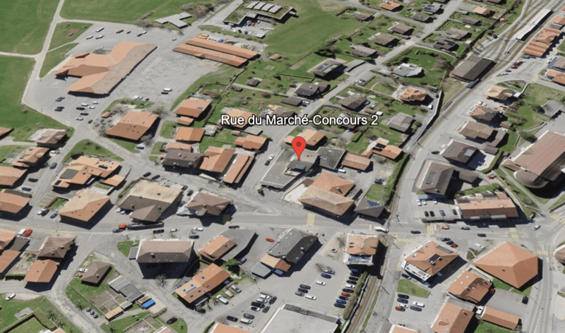 Aerial view of a neighborhood with multiple houses, a road, and a parking lot.