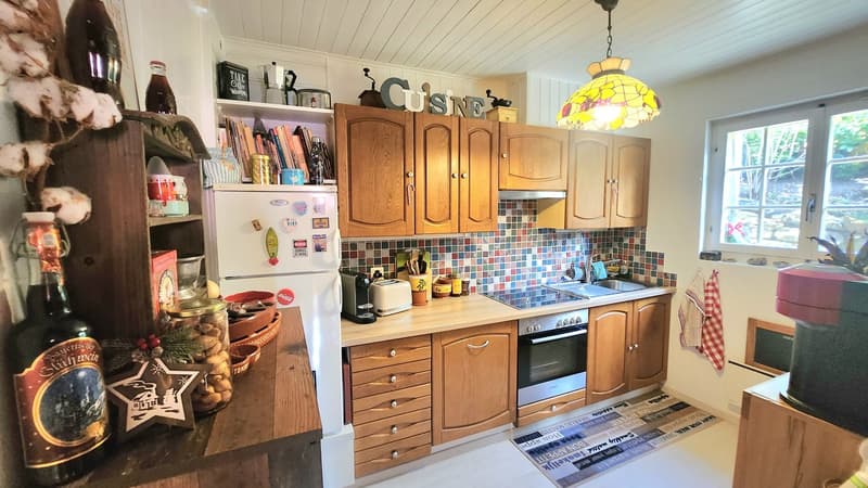 kitchen with wooden cabinets, white refrigerator, wooden countertop, gas stove, sink, window, decorative items