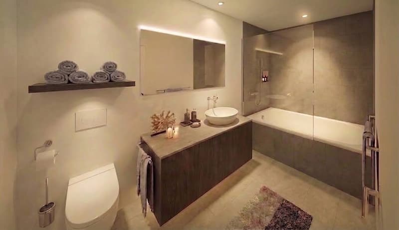 Bathroom with white walls, modern sink, bathtub, toilet, mirror, and towel rack