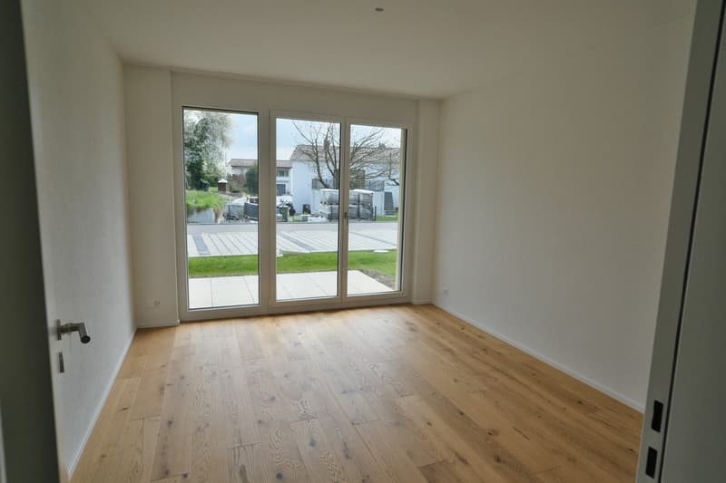 empty room, wooden floor, sliding glass doors, white walls, view of the outside