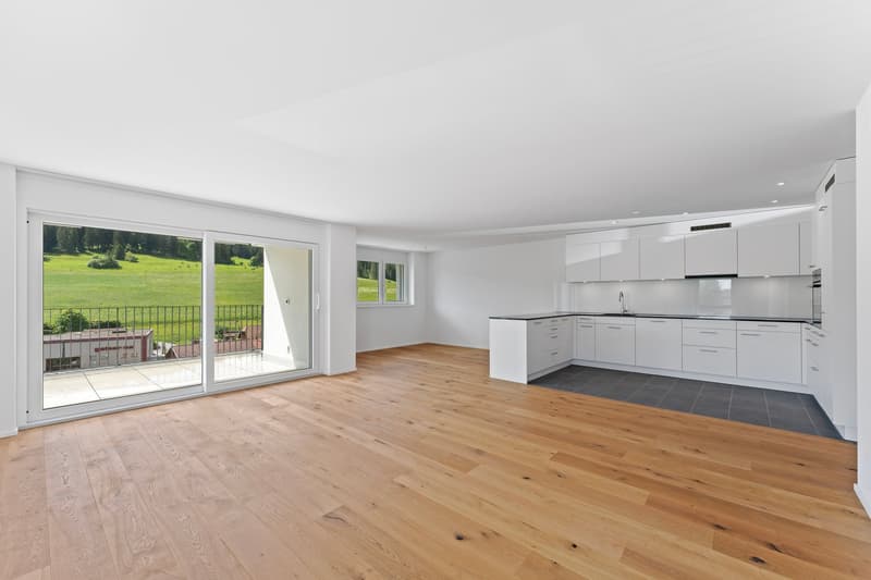 modern kitchen with sliding doors, hardwood floors, balcony with railings, kitchen island, large windows, scenic view