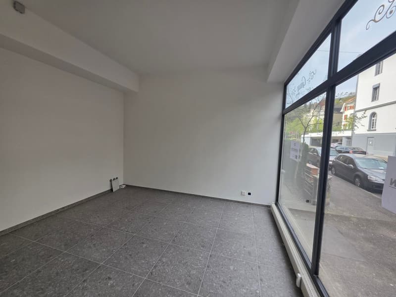 empty room, white walls, gray tiles, large windows, power outlet