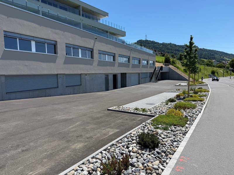 Two story building, concrete construction, 2 garages, large parking lot