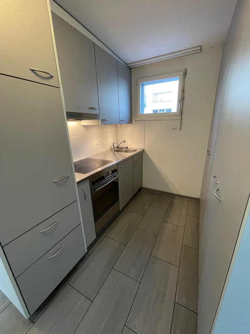 kitchen with tiled floor, oven, gas stove, drawers, cabinets, kitchen sink, window
