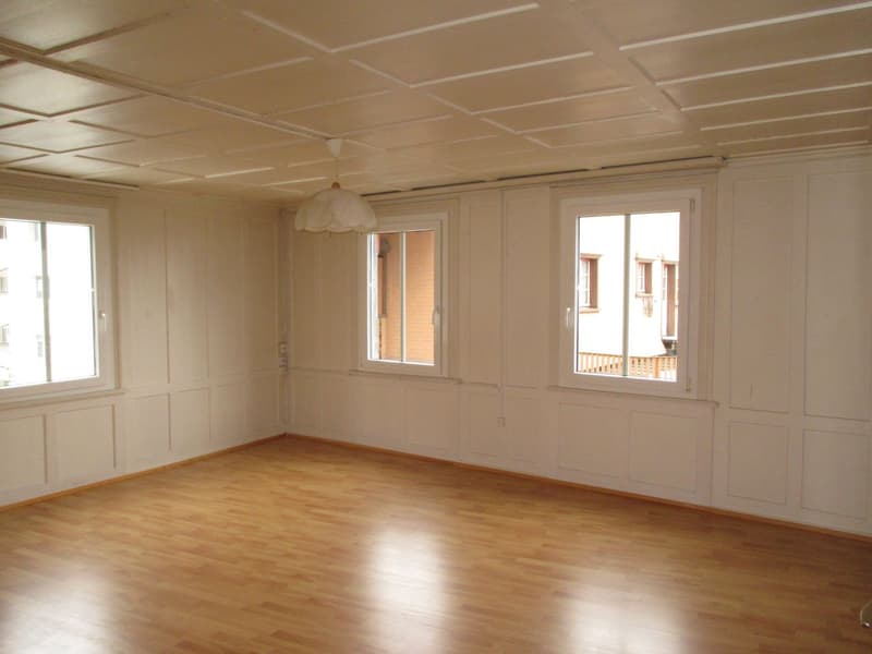 wooden floor, white walls, ceiling, pendant light, two windows, hallway door