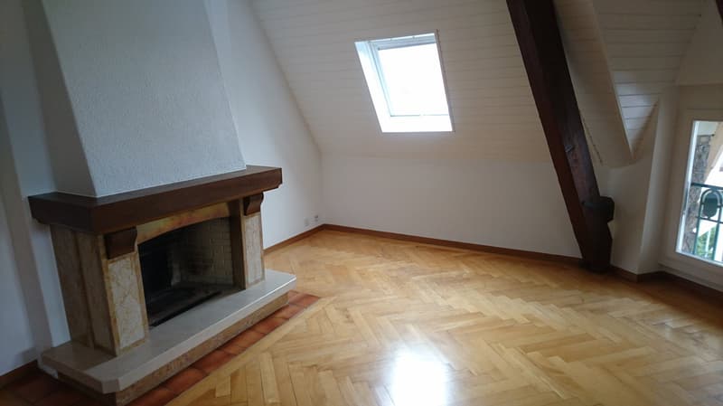 hardwood floor, fireplace, slanted ceiling, small window