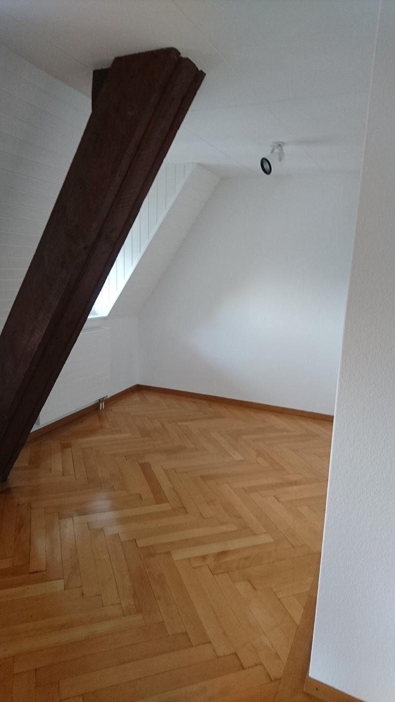 white walls, wooden floor, window, camera
