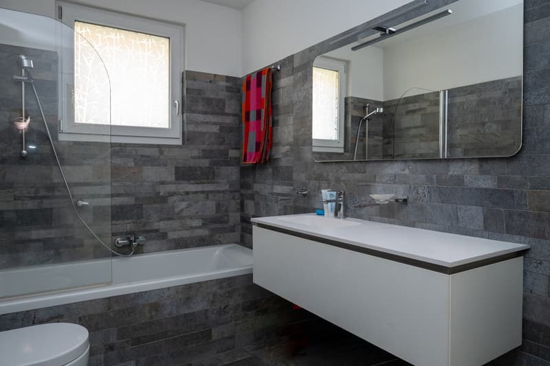 Bathroom with bathtub, shower, sink, and mirror