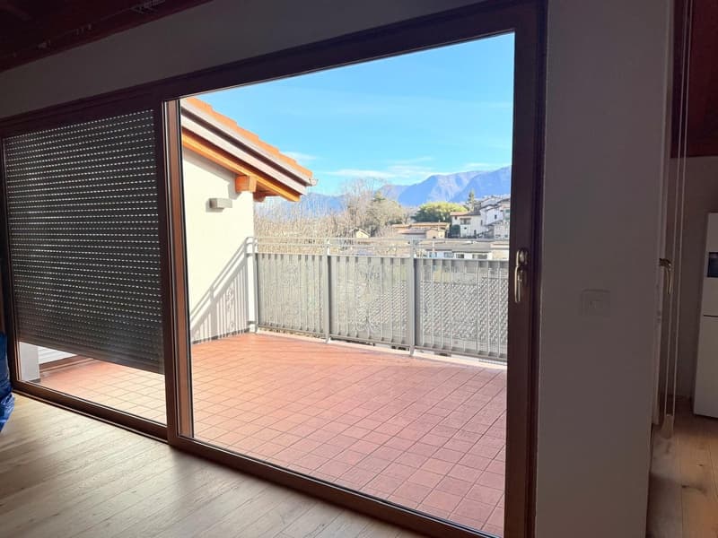 sliding glass door, balcony, tiled floor, metal railing, view of mountains