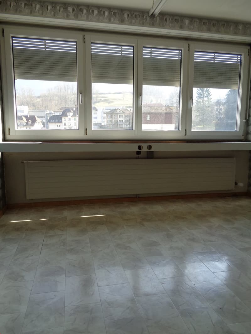 tiled floor, large window with blinds, radiator underneath