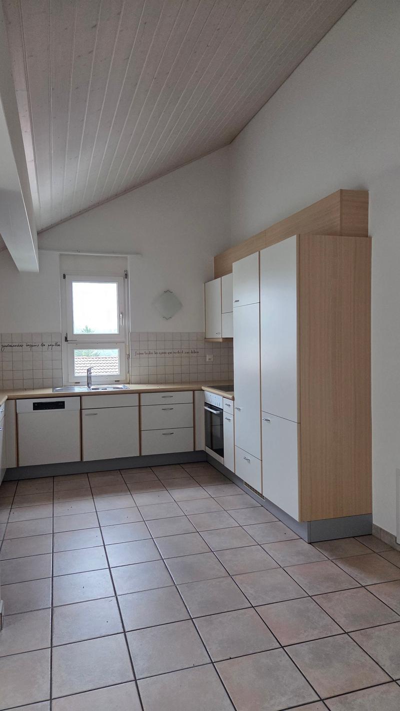 modern kitchen, tile flooring, white cabinets, wooden countertops, stainless steel sink, dishwasher, washing machine, oven