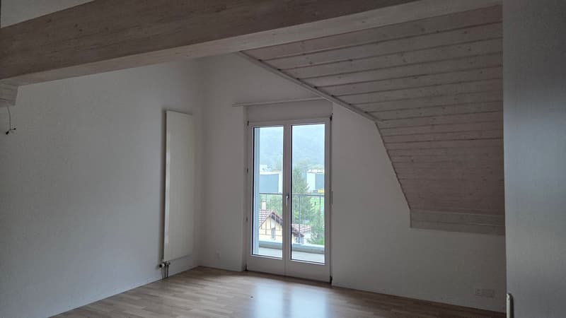 empty room with sliding glass door leading to a balcony