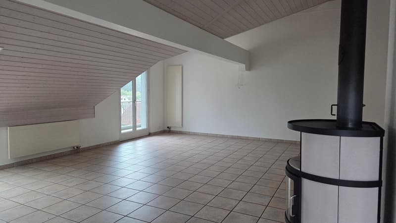 empty room with tile flooring, two heaters, and a fireplace