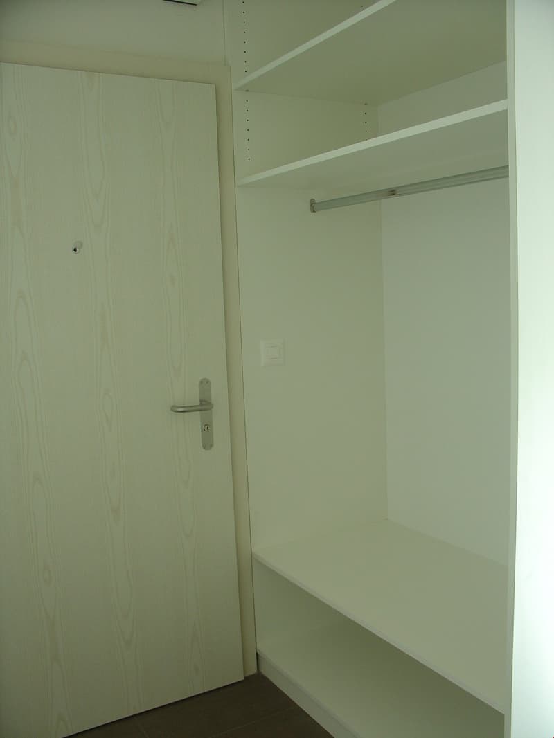white door, white wardrobe, white shelves, floor and wall