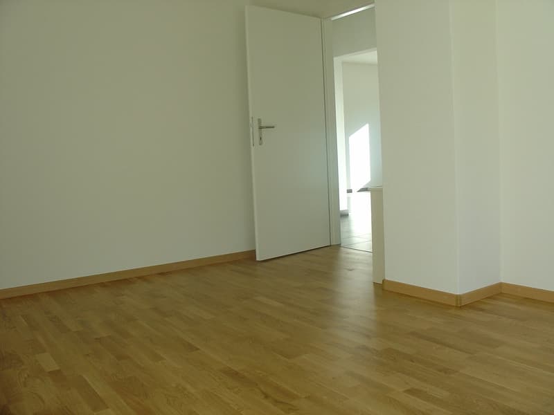 empty room, hardwood floor, white walls, open door