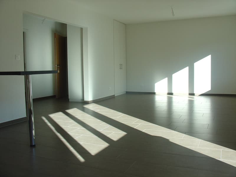 Empty room, tile floor, white walls, 3 windows, cabinet, and open door