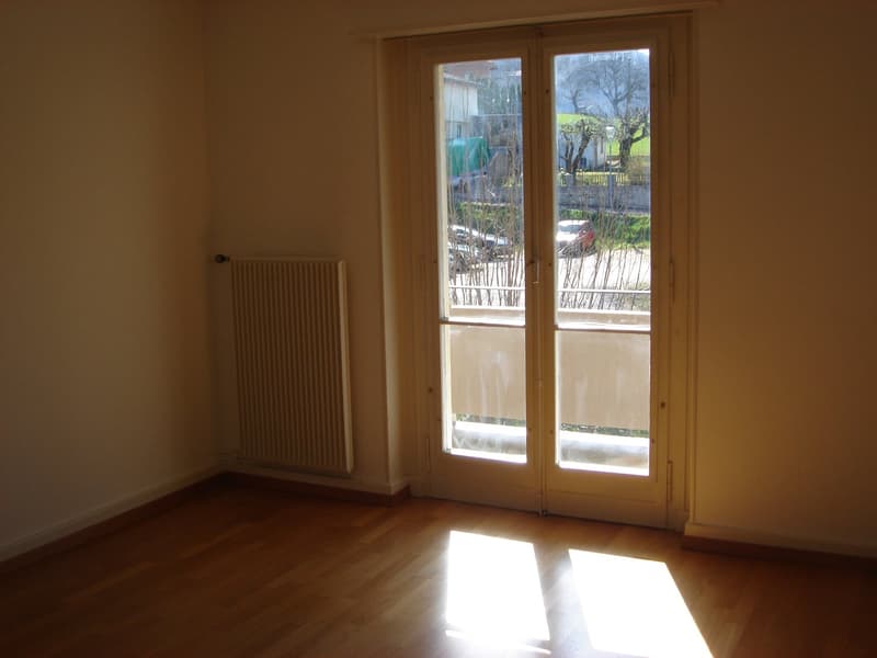 empty room, wooden floor, white walls, glass door, radiator, view of outside
