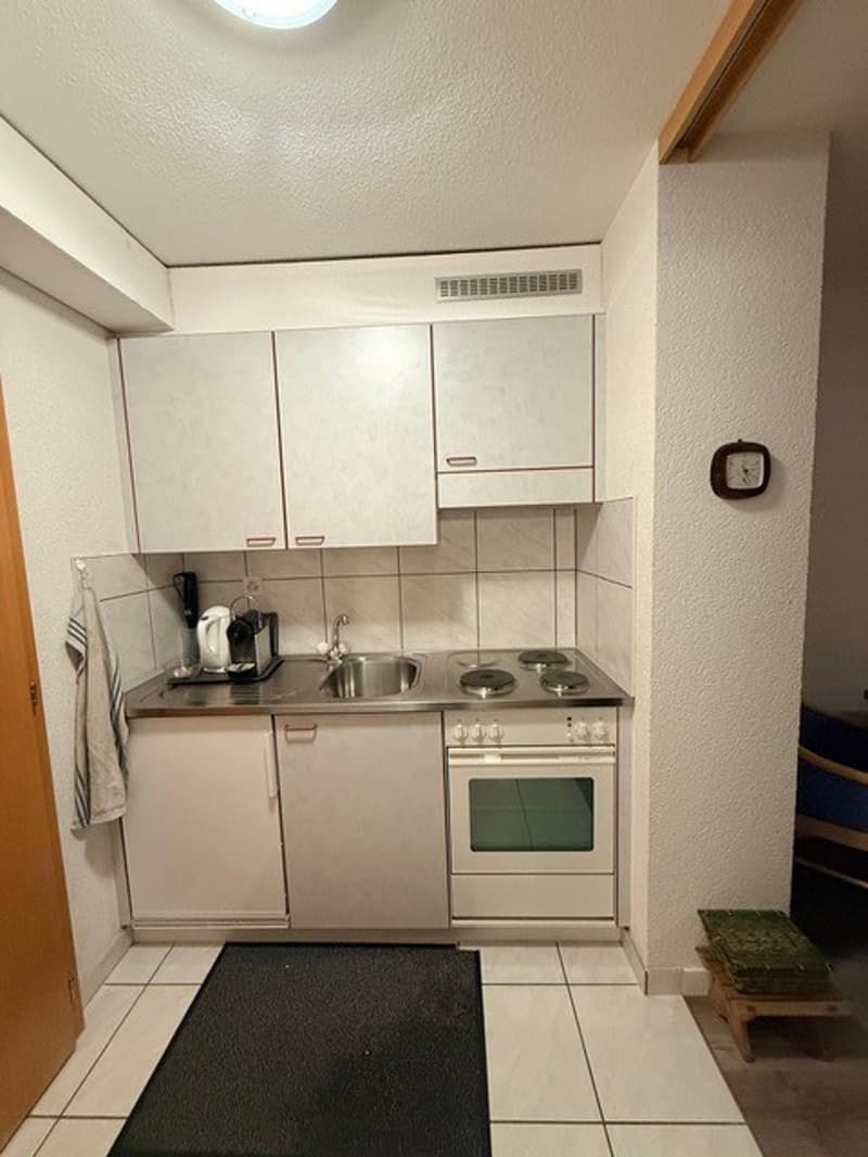 White kitchen, tiled floors, stainless steel kitchen appliances, white cabinets