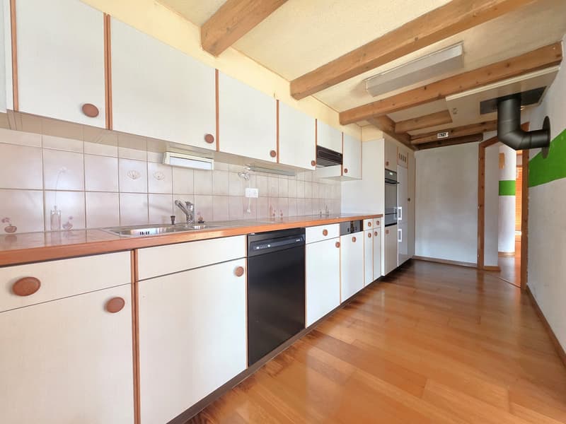 modern kitchen with white cabinets, wooden countertops, stainless steel sink, dishwasher, wooden floor