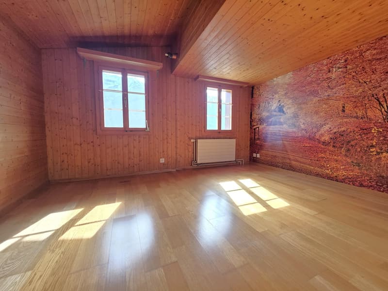 empty room, wooden walls, wooden floor, two windows, radiator