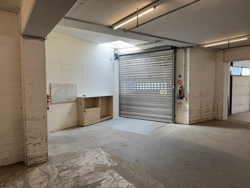 empty garage, single roll-up door, storage box, and small map