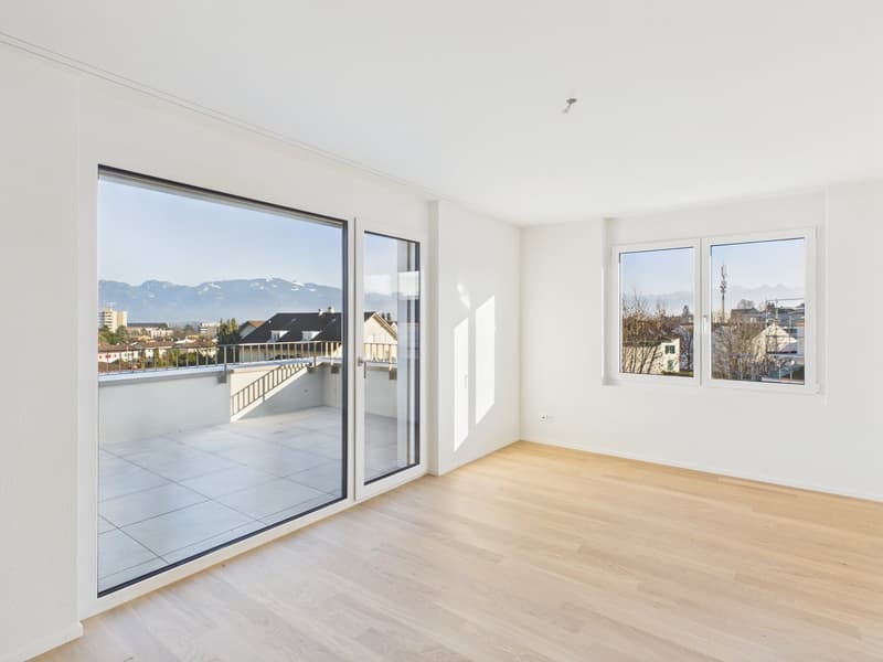 empty room, large windows, balcony with tile flooring, view of mountains