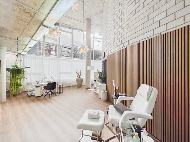 Minimalistic interior with wooden flooring, white walls, two chairs, desk, and a large glass window.