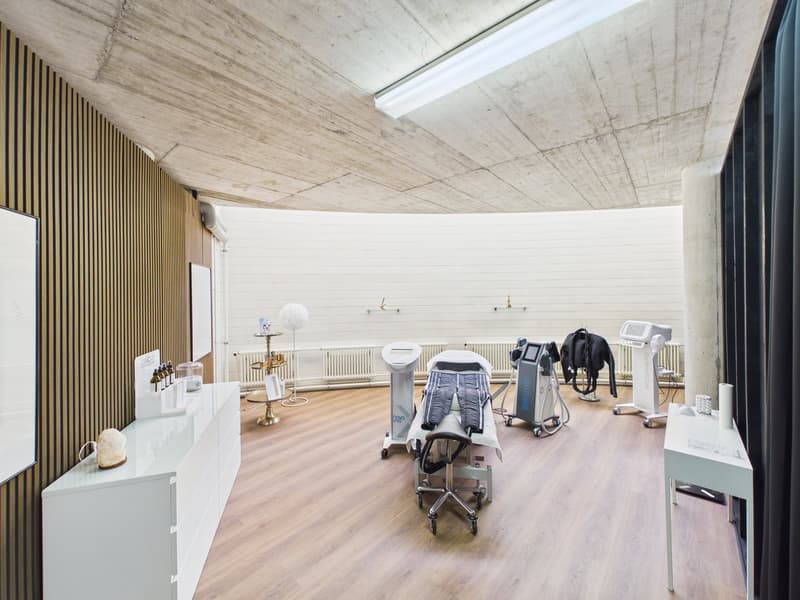 treatment room, white walls, wooden floor, white desks, medical equipment
